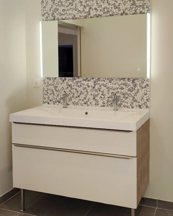 Cuisine moderne avec armoires blanches à panneaux surélevés, plan de travail en quartz gris, dosseret en carreaux métro blancs